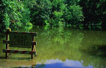 Water flooding with "Road Closed" sign